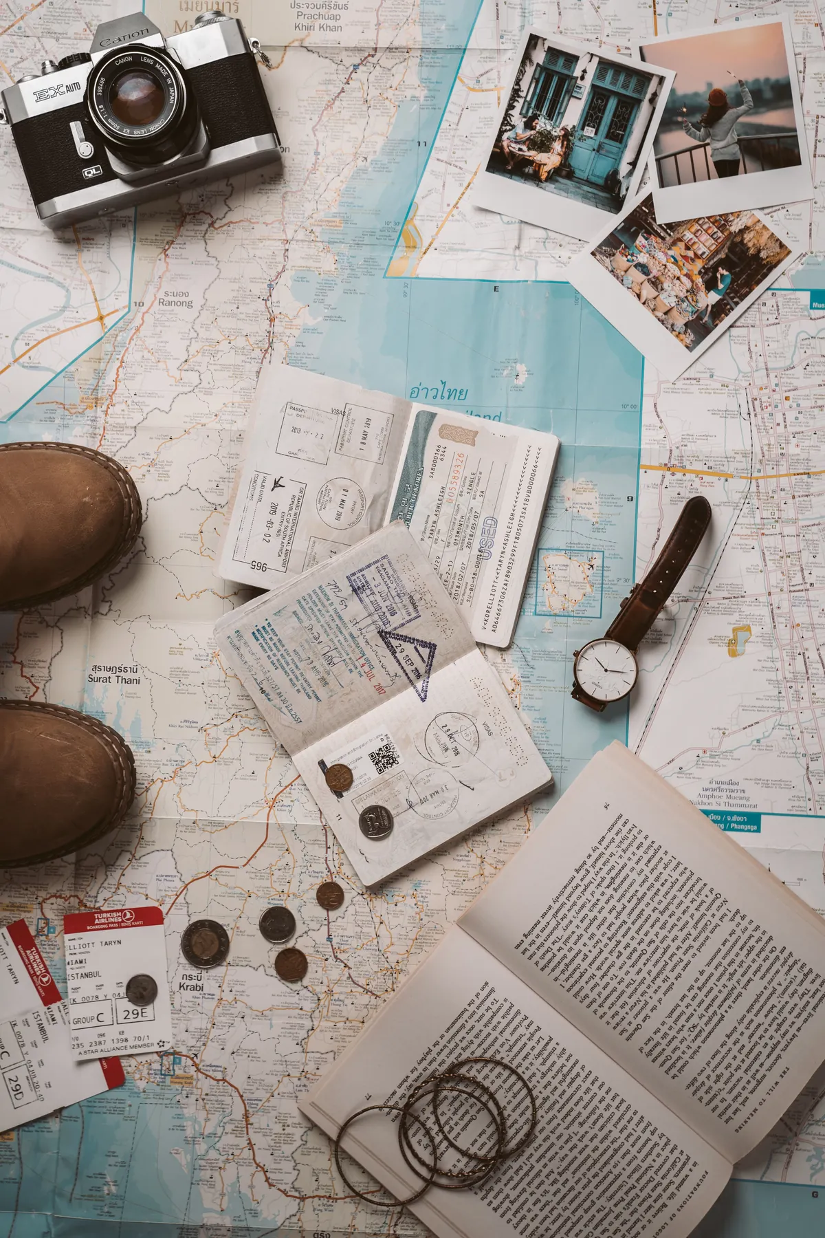 Travel maps, notes and planning materials arranged on a table